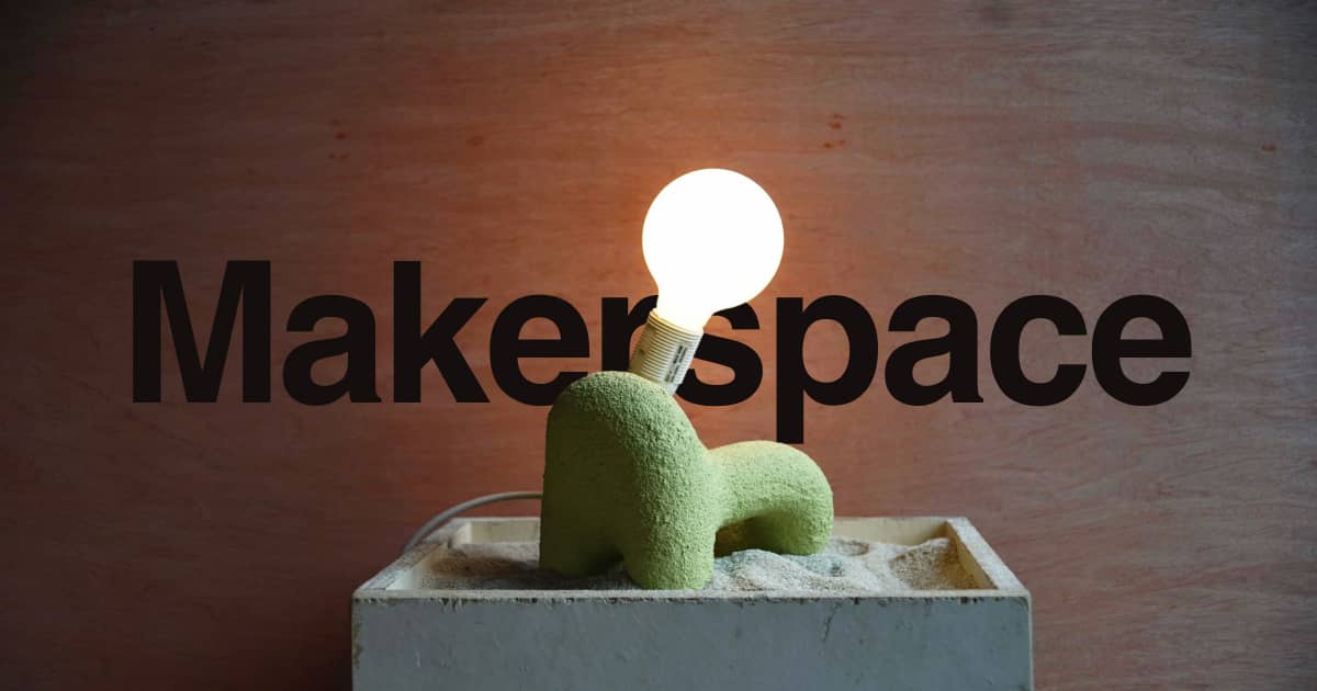 Makerspace wordmark behind a sculptural green lamp